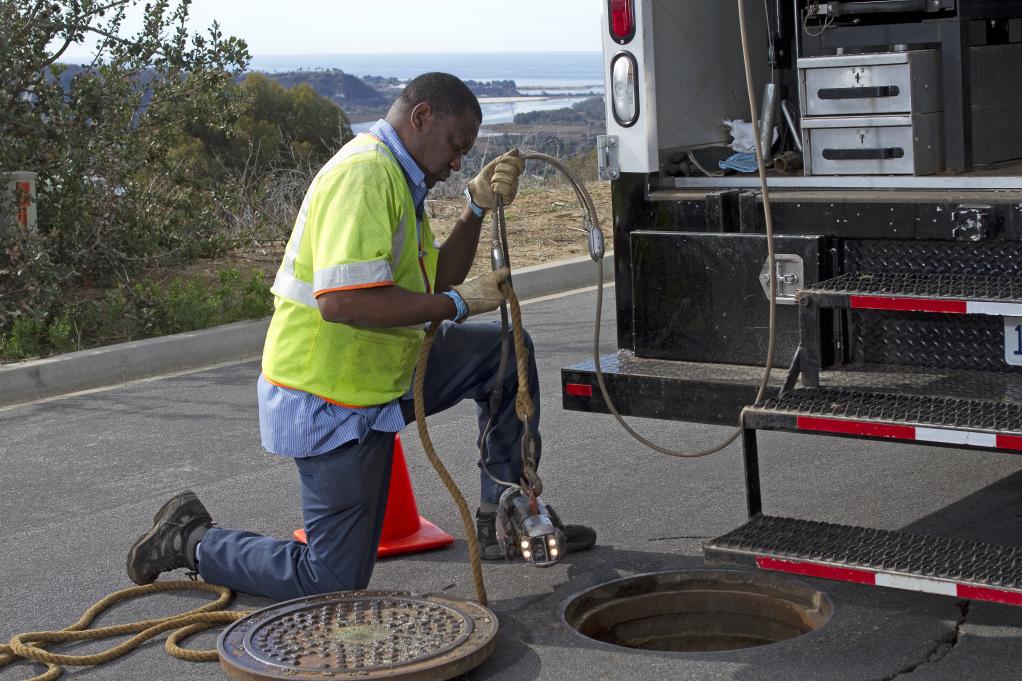 Crew member working on one of District’s collection system 5,000 manholes