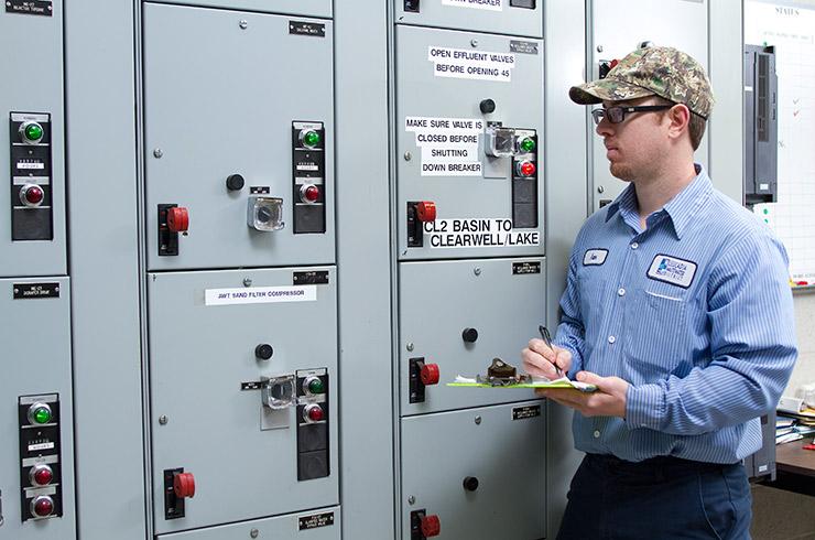 Field service department member inspects equipment.
